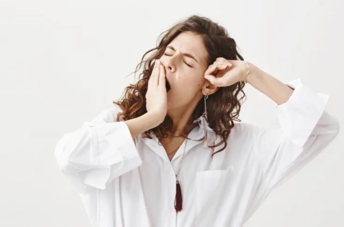 stylish-sleepy-woman-wake-up-yawning-stretching-768x512